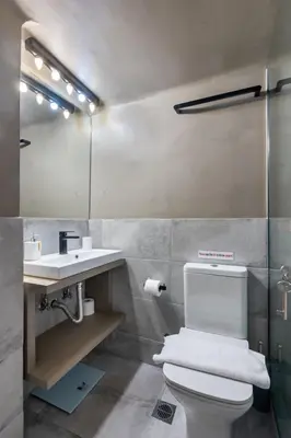 a bathroom with a white toilet and a sink at Elvis 2-Bedroom Apartment in Athens in Athens