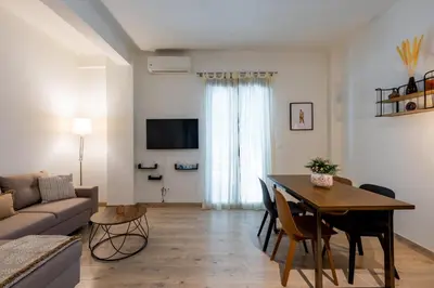 a living room with a table and a couch at Elvis 2-Bedroom Apartment in Athens in Athens