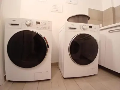 two washing machines sitting next to each other in a kitchen at Elvis 2-Bedroom Apartment in Athens in Athens