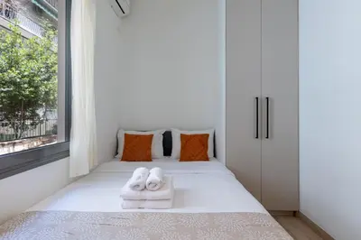a bedroom with a bed with towels on it at Elvis 2-Bedroom Apartment in Athens in Athens