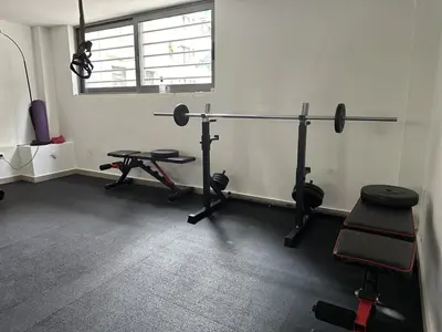 a room with a gym with two bikes and weights at Elvis 2-Bedroom Apartment in Athens in Athens