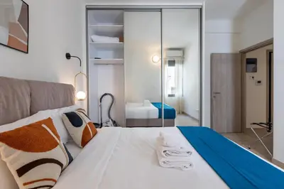 a bedroom with a bed with a mirror at Elvis 2-Bedroom Apartment in Athens in Athens