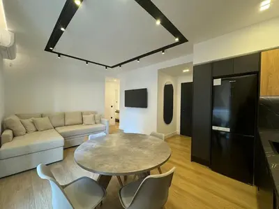 a living room with a table and a couch at BlueMotion - PortSuite 4A in Piraeus