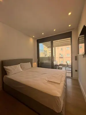 a bedroom with a large bed and a large window at BlueMotion - PortSuite 4A in Piraeus