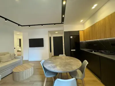 a living room with a table and chairs and a couch at BlueMotion - PortSuite 4A in Piraeus