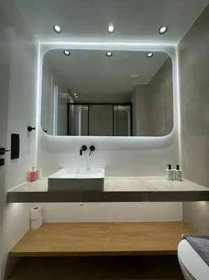 a bathroom with a sink and a large mirror at BlueMotion - PortSuite 4A in Piraeus