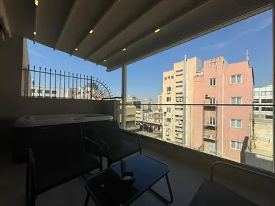 a chair in a room with a large window at BlueMotion - PortSuite 4A in Piraeus
