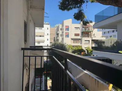 an apartment balcony with a view of buildings at Charming Flat in Glyfada Center in Athens