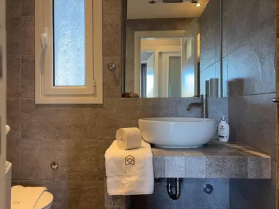 a bathroom with a sink and a mirror at Charming Flat in Glyfada Center in Athens