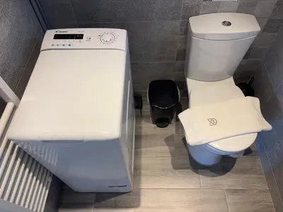 a small bathroom with a toilet and a sink at Charming Flat in Glyfada Center in Athens