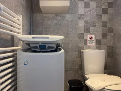 a bathroom with a toilet and a sink at Charming Flat in Glyfada Center in Athens