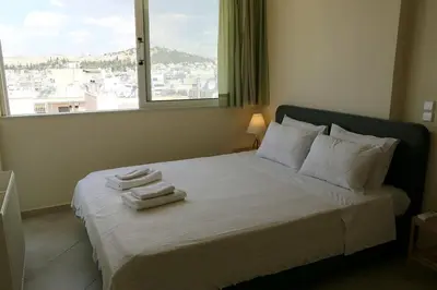 a bedroom with a bed with towels on it at Fly me to the moon! in Athens