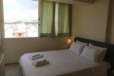 a bedroom with a bed with towels on it at Fly me to the moon! in Athens