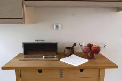 a counter with a bowl of fruit and a bowl of apples at Fly me to the moon! in Athens