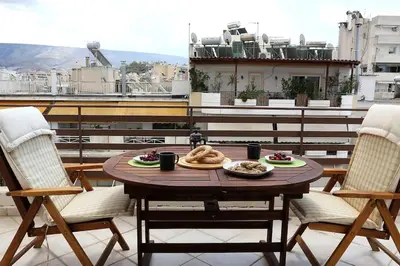 a table with food on top of a balcony at Fly me to the moon! in Athens