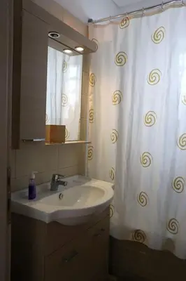 a bathroom with a sink and a shower curtain at Fly me to the moon! in Athens