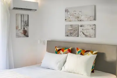 a bedroom with a bed with white pillows at Halo - Luxury Studio in Athens in Athens