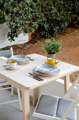 a white table with two plates and a plant on it at Halo - Luxury Studio in Athens in Athens