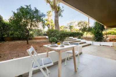a table and chairs on a patio with trees at Halo - Luxury Studio in Athens in Athens