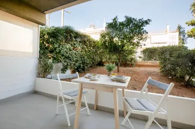 a white table and chairs on a patio at Halo - Luxury Studio in Athens in Athens