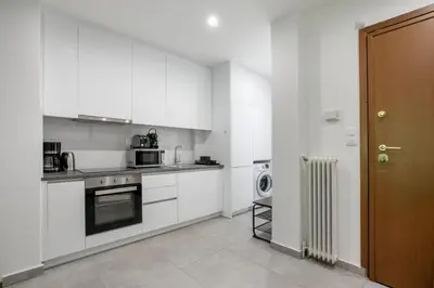 a kitchen with white cabinets and a stove top oven at Mellow 2-Bedroom Apartment in Athens in Athens