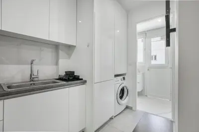 a white kitchen with a sink and a washing machine at Mellow 2-Bedroom Apartment in Athens in Athens