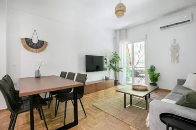 a living room with a table and a couch at Mellow 2-Bedroom Apartment in Athens in Athens