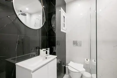 a bathroom with a sink and a toilet and a mirror at Mellow 2-Bedroom Apartment in Athens in Athens