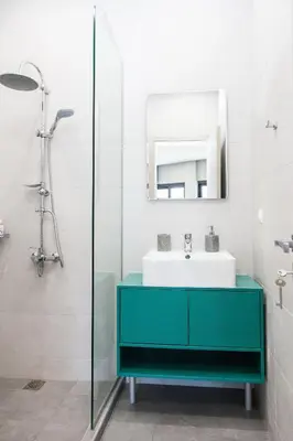 a bathroom with a green sink and a mirror at Elegant Rooms Athens in Athens