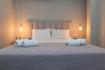 a bedroom with a large bed with two pillows on it at Elegant Rooms Athens in Athens