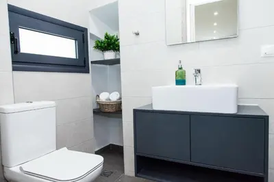 a bathroom with a white toilet and a sink at Elegant Rooms Athens in Athens