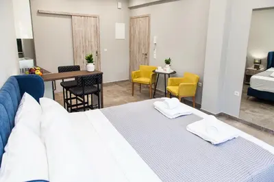 a hotel room with a bed and a table and chairs at Elegant Rooms Athens in Athens