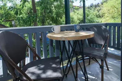 a small table and two chairs on a balcony at Elegant Rooms Athens in Athens