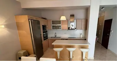 a kitchen with a counter and stools in it at Cityacropol in Athens