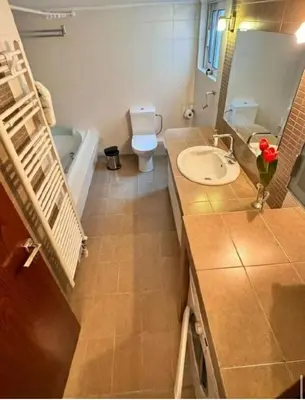 a bathroom with a sink and a toilet and a tub at Cityacropol in Athens