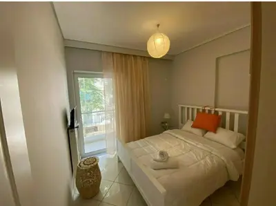 a bedroom with a white bed and a window at Cityacropol in Athens