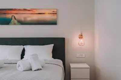 a bedroom with a bed with towels on it at ACM Acropolis Apartments in Athens