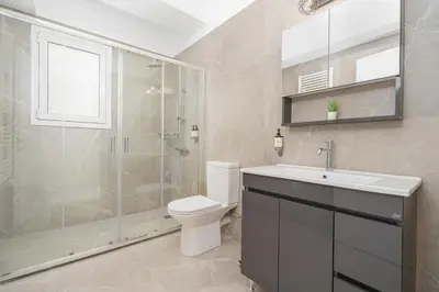 a bathroom with a shower and a toilet and a sink at ACM Acropolis Apartments in Athens
