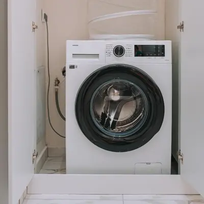a white washing machine sitting in a room at ACM Acropolis Apartments in Athens