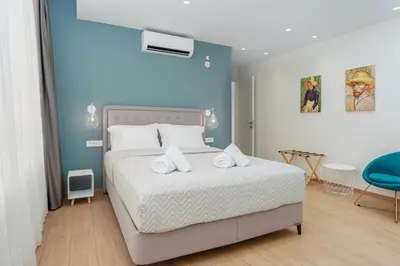 a bedroom with a bed with two towels on it at ACM Acropolis Apartments in Athens