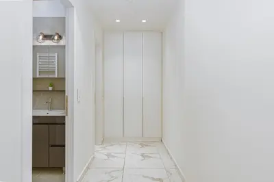 a kitchen with white walls and a white closet at ACM Acropolis Apartments in Athens