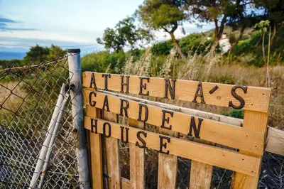 a wooden sign that at Athena's Garden House in Porto Rafti