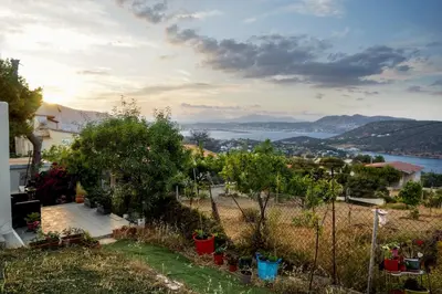 a garden with a view of the water at Athena's Garden House in Porto Rafti