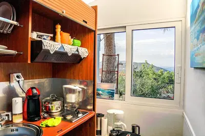 a kitchen with a sink and a window at Athena's Garden House in Porto Rafti