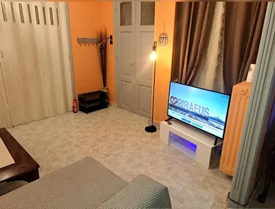 a living room with a flat screen tv on a stand at Horizon view apartment port of Piraeus in Piraeus