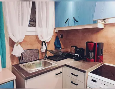a small kitchen with a sink and blue cabinets at Horizon view apartment port of Piraeus in Piraeus