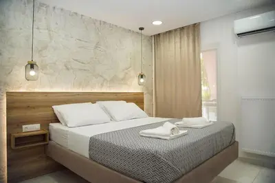 a bedroom with a bed with two towels on it at Urban Elegance Retreat VIPGreece in Athens