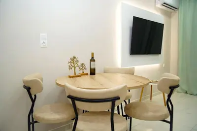 a dining room with a table and a bottle of wine at Urban Elegance Retreat VIPGreece in Athens