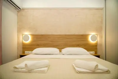 a large bed with two white towels on it at Urban Elegance Retreat VIPGreece in Athens