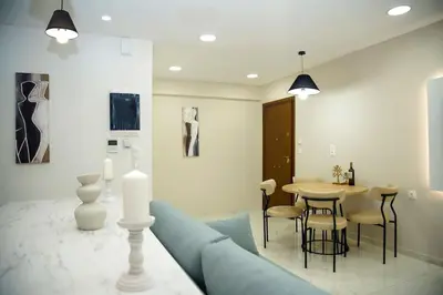 a living room with a blue couch and a table at Urban Elegance Retreat VIPGreece in Athens